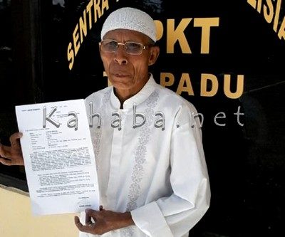 Nurdin menunjukan surat laporan didepan SPKT Polres Bima Kota usai melapor Bunyamin. Foto; Eric